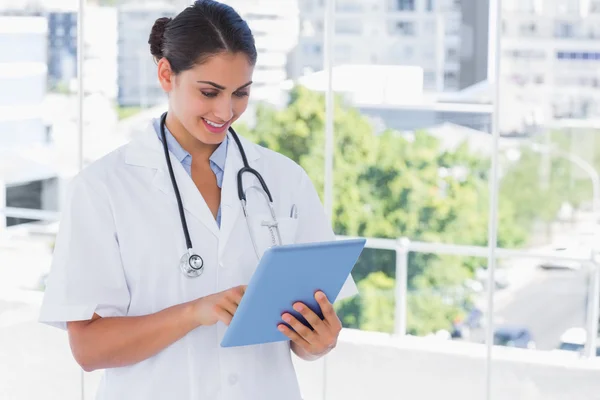 Smiling young doctor using tablet pc — Stock Photo, Image