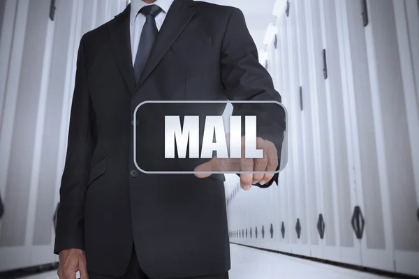 Businessman in a data center selecting label with mail — Stock Photo, Image