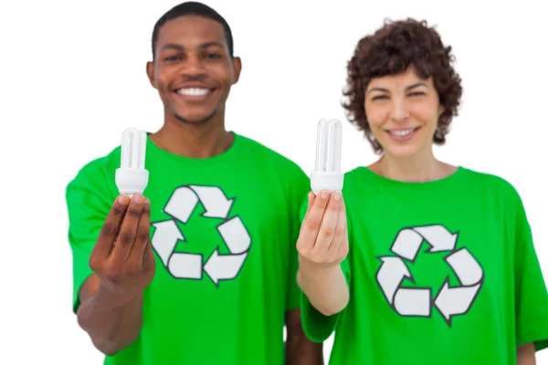 Two environmental activists holding light bulbs — Stock Photo, Image