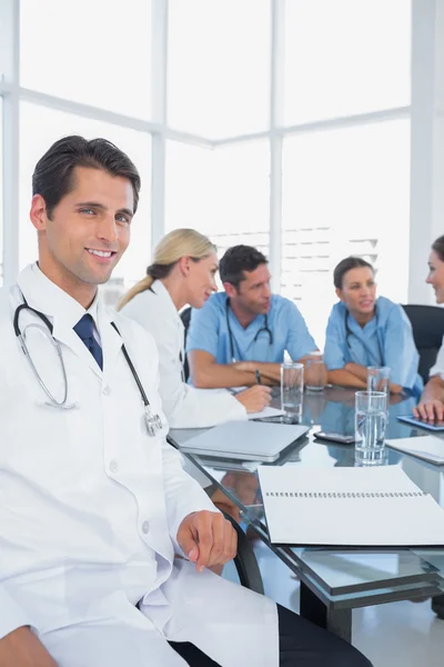 Attractive doctor smiling to the camera — Stock Photo, Image