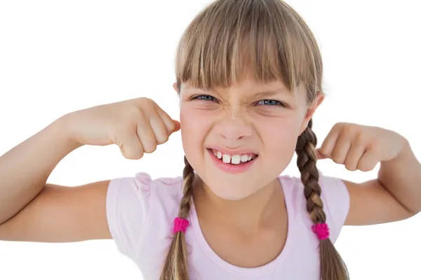 Little girl tensing her arm muscles — Stock Photo, Image