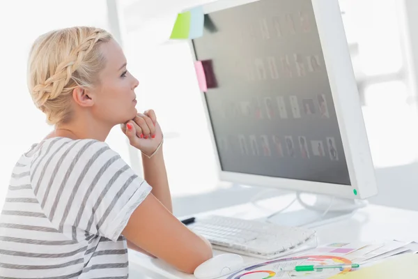 Thoughtful photo editor looking at her screen — Stock Photo, Image