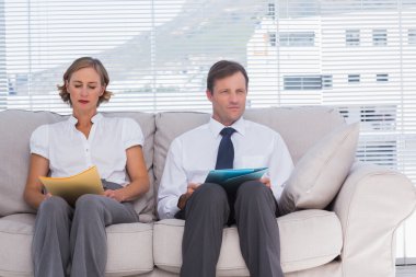 Two business sitting on couch clipart