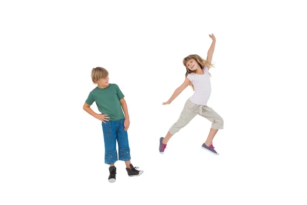 Happy little boy and girl jumping — Stock Photo, Image