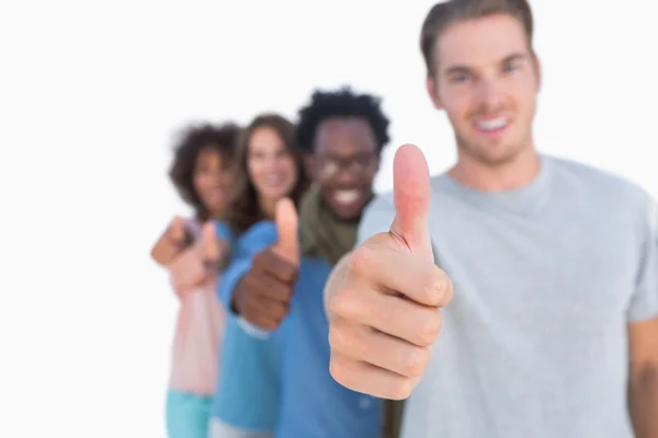Young in row with thumbs up — Stock Photo, Image