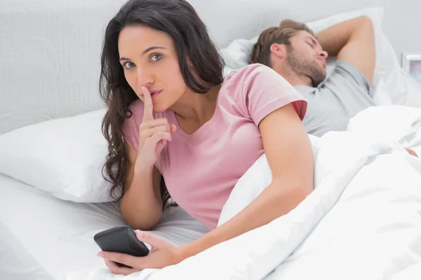 Woman doing a quiet sign while text messaging — Stock Photo, Image