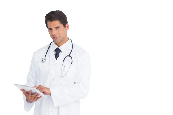 Handsome doctor using a tablet — Stock Photo, Image