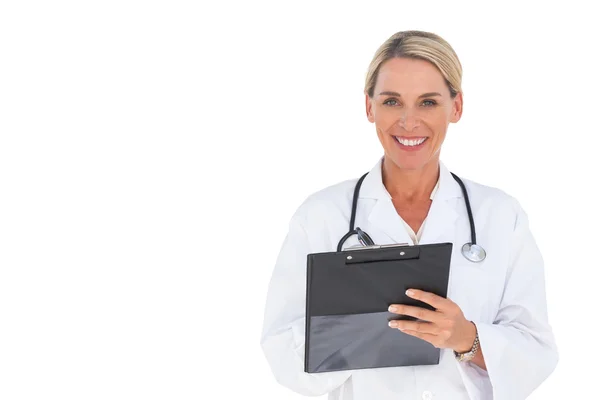 Happy doctor writing on a clipboard — Stock Photo, Image