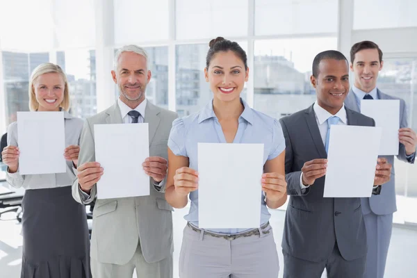 Business team showing blank pages — Stock Photo, Image