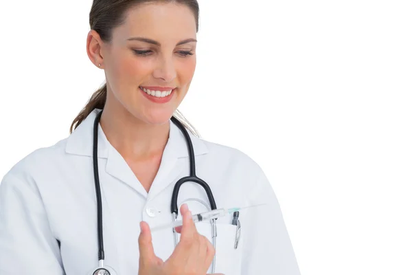 Happy nurse holding a syringe — Stock Photo, Image