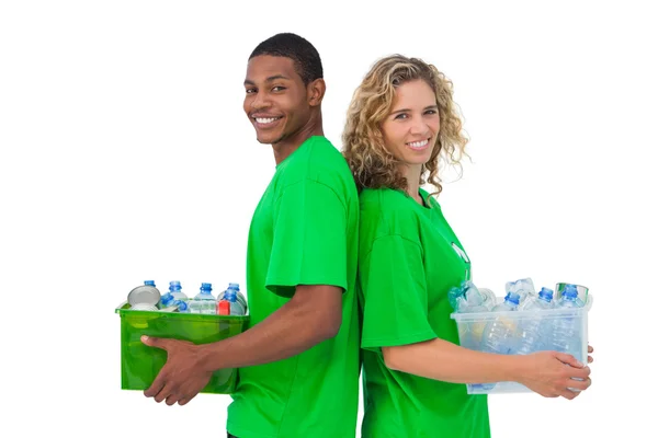 Cheerful environmental activists holding box of recyclables and — Stock Photo, Image