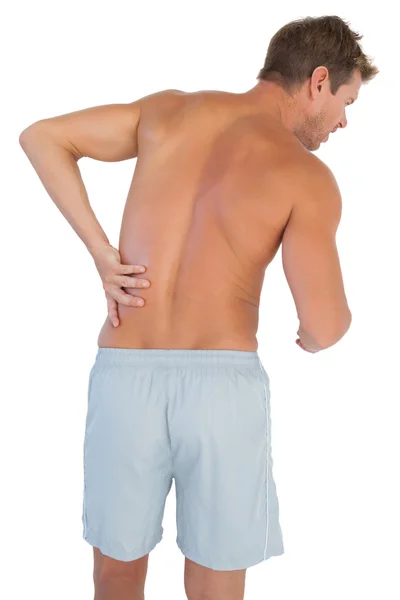 Man with shorts suffering from lower back pain — Stock Photo, Image