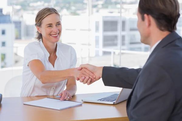 Cheerful interviewer shaking hand of an interviewee — Stock Photo, Image