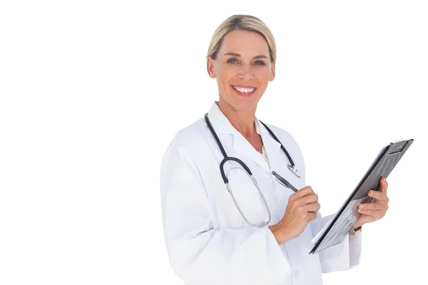 Happy doctor holding pen and clipboard — Stock Photo, Image