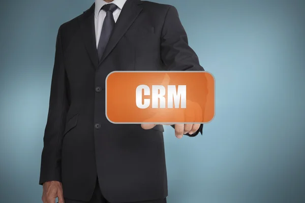 Zakenman oranje label selecteren met het woord crm geschreven op het — Stockfoto