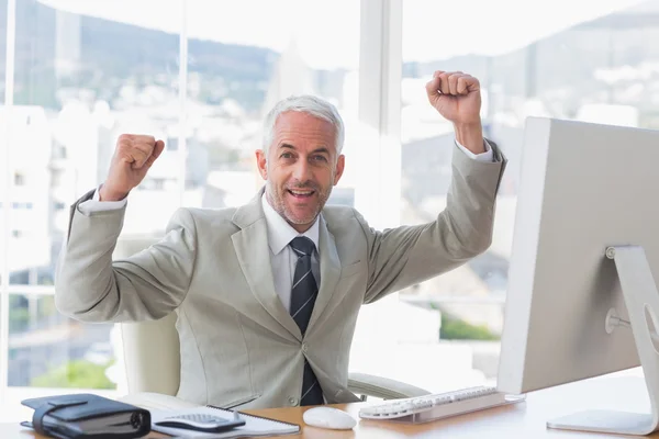 Businessman cheering in his office — Stock Photo, Image