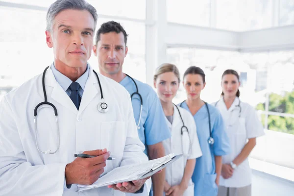 Serious medical team in row — Stock Photo, Image