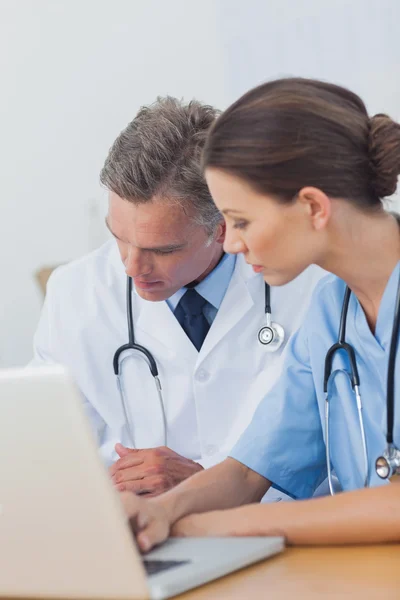 Two doctors working on a folded — Stock Photo, Image