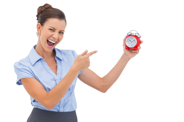 Businesswoman indicating alarm clock — Stock Photo, Image