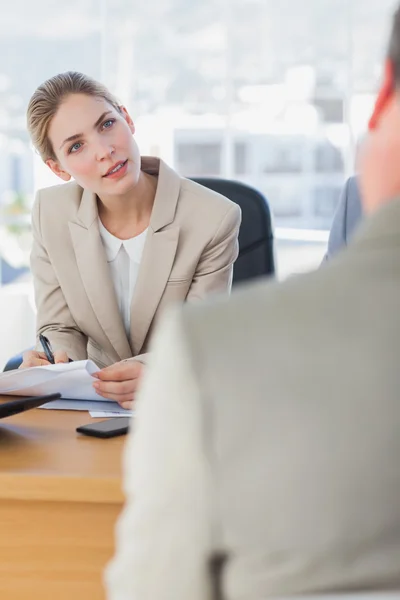 Smiling businesswoman looking at interviewee — Stock Photo, Image