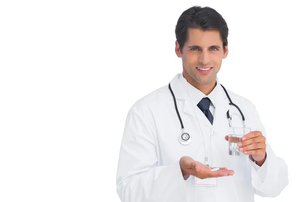 Happy doctor smiling and holding medicine — Stock Photo, Image