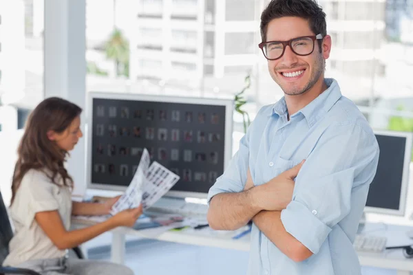 Handsome photo editor standing with arms folded — Stock Photo, Image