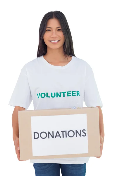 Smiling volunteer holding a donation box — Stock Photo, Image