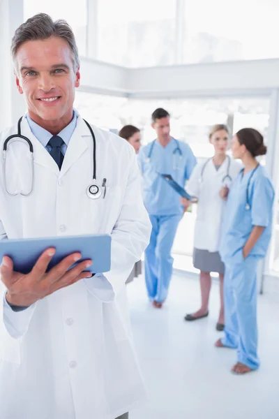 Cheerful doctor holding digital tablet — Stock Photo, Image