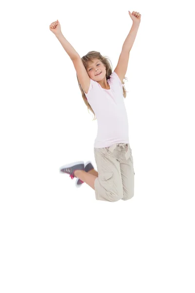 Little girl jumping and putting her hands up — Stockfoto