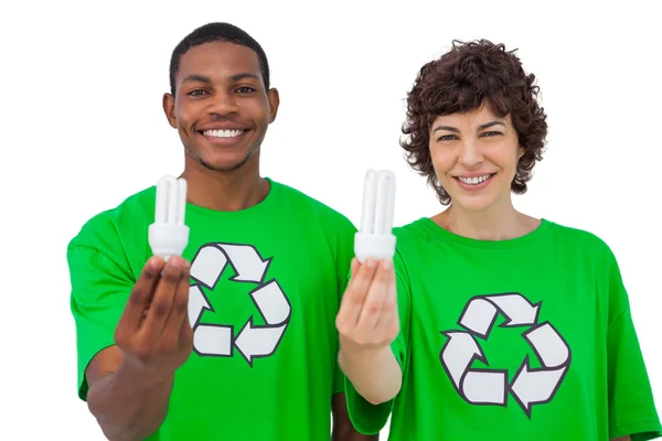 Environmental activists holding energy saving light bulbs — Stock Photo, Image