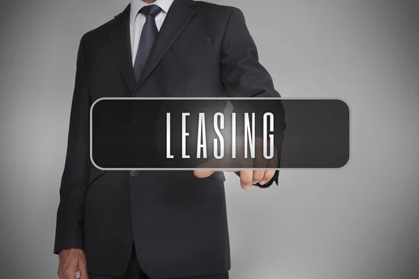 Businessman selecting label with leasing written on it — Stock Photo, Image