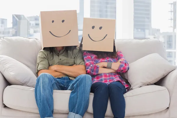 Funny workers with arms crossed wearing boxes on their heads — Stock Photo, Image