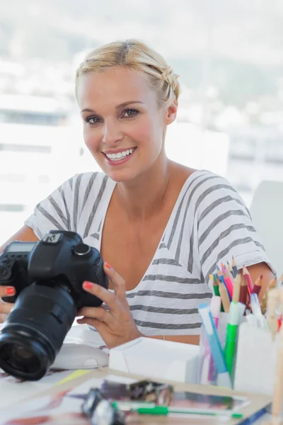 Photo editor looking at her digital camera — Stock Photo, Image