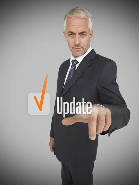 Businessman selecting the word update — Stock Photo, Image