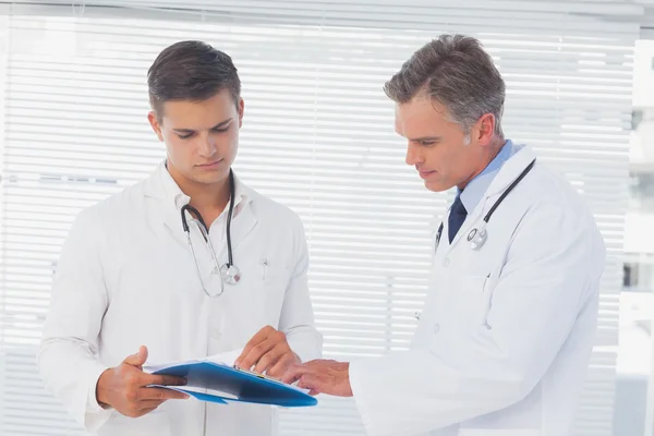 Doctors reading a folder — Stock Photo, Image