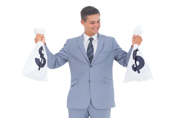 Businessman looking at cash bag — Stock Photo, Image