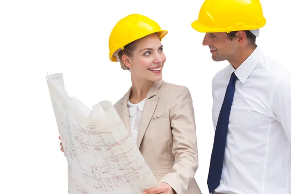Architect team looking at each other with construction plan — Stock Photo, Image