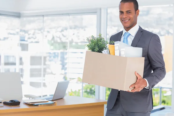 Smiling businessman leaving his company — Stock Photo, Image