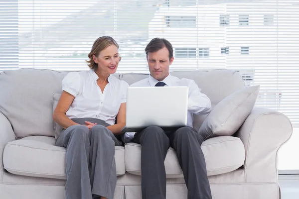 Businessman pointing something on laptop to her colleague — Stock Photo, Image