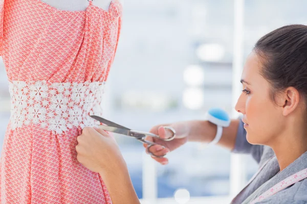 Fashion designer cutting dress — Stock Photo, Image