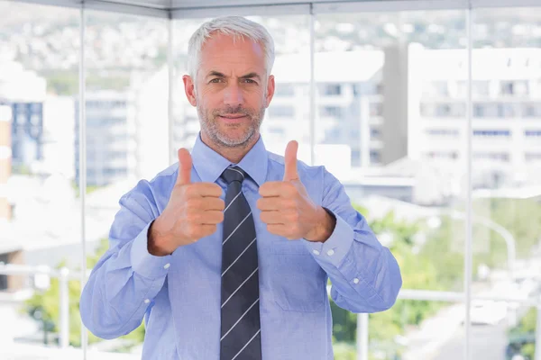 Businessman smiling with his thumbs up — Stock Photo, Image