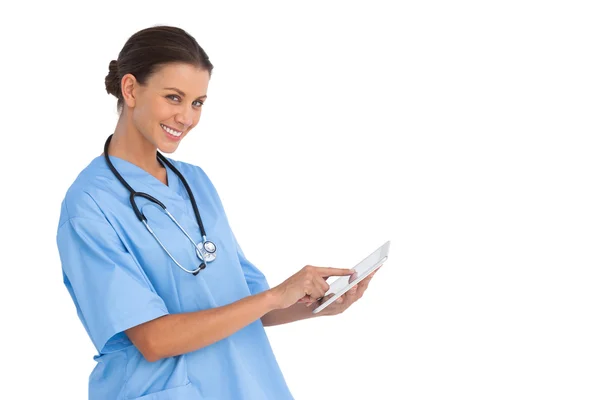 Happy surgeon working on digital tablet Stock Picture