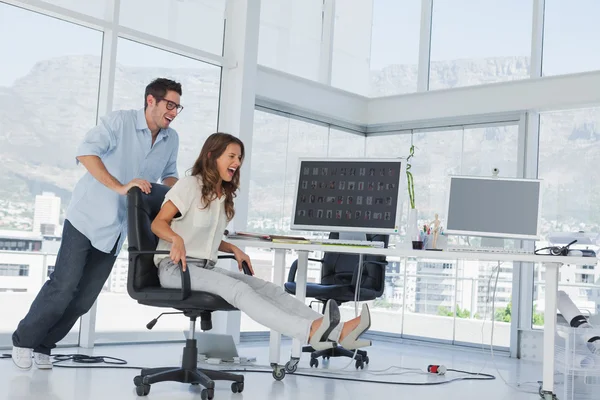 Designers having fun with a swivel chair Stock Image