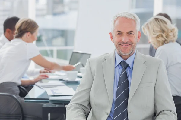 Charismatic businessman posing in the boardroom — Stock Photo, Image