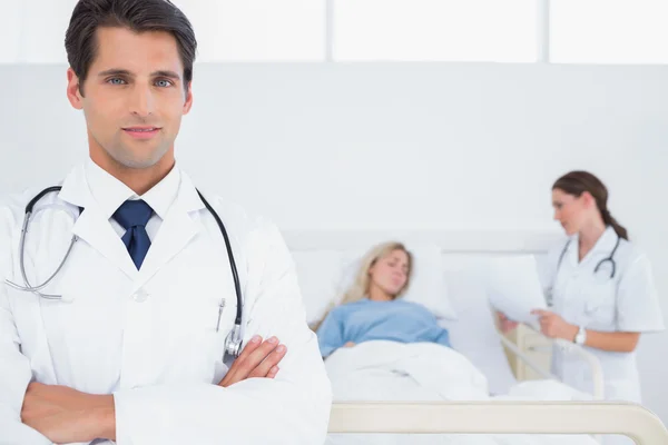 Handsome doctor with arms crossed Stock Image