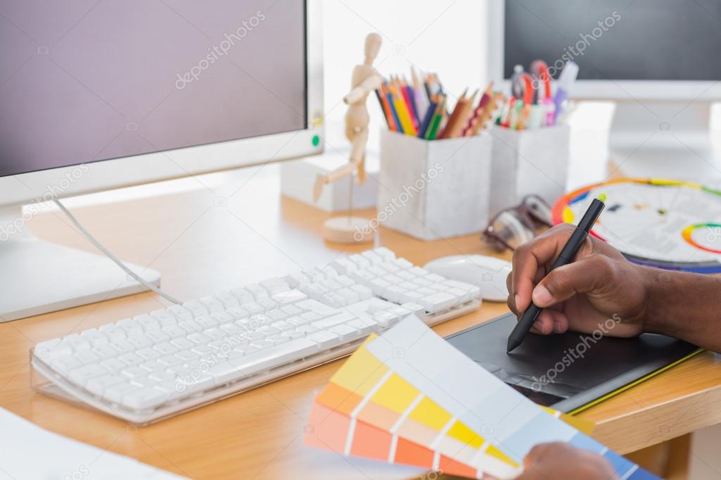 Designer using a graphics tablet Stock Photo by ©Wavebreakmedia 26990269