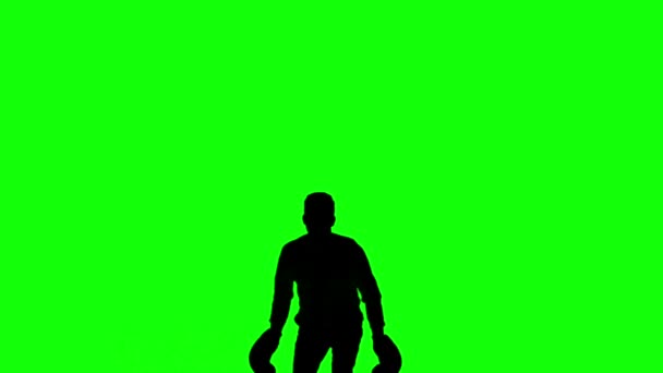 Silhouette von Mann springt und boxt auf grünem Bildschirm — Stockvideo