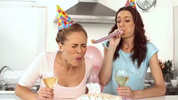 Woman blowing candle and celebrating her birthday with a friend — Stock Video