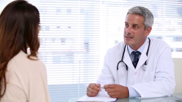 Smiling doctor talking to patient — Stock Video