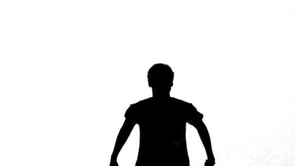 Silhouette of a man jumping with raised arms on white background — Stock Video